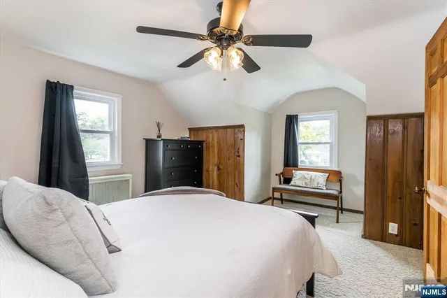 a bedroom with a bed closet and a window