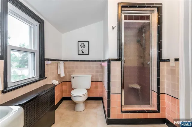 a bathroom with a toilet and a shower