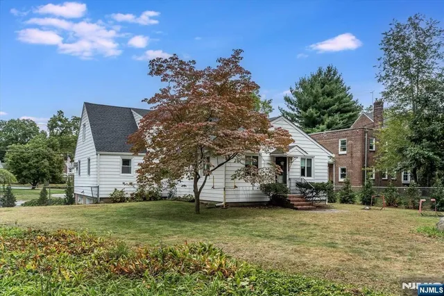 a view of house with outdoor space and garden