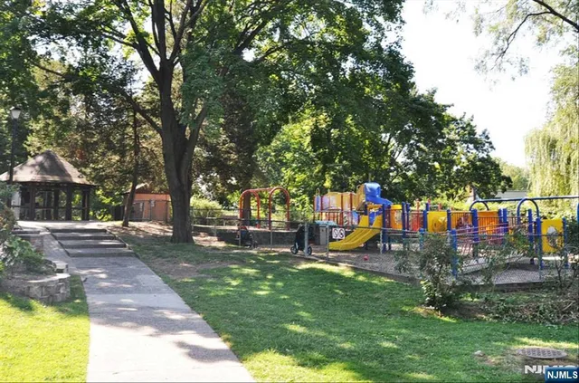 a view of a park with swings and slides