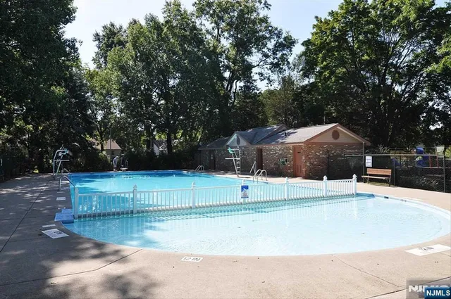 a view of a swimming pool with a yard
