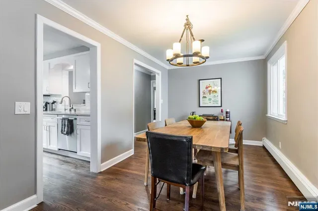a view of a dining room with furniture wooden floor and chandelier