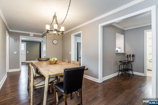 a view of a dining room with furniture wooden floor and chandelier
