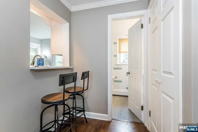 a view of a room with furniture and wooden floor