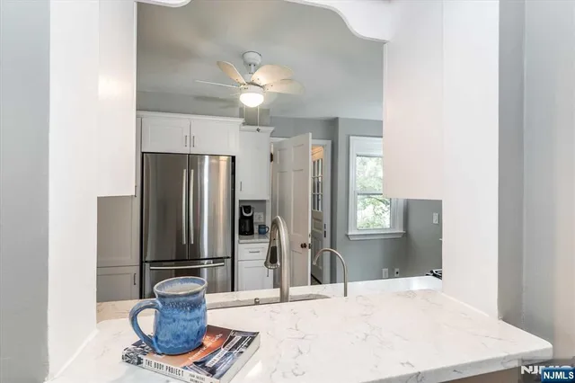 a kitchen with a refrigerator and a sink