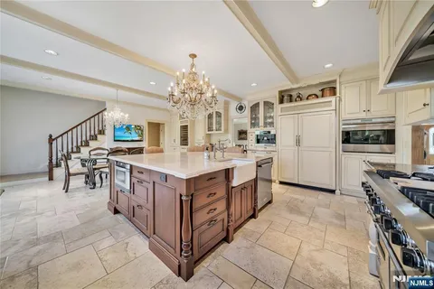 a kitchen with stainless steel appliances a sink stove and cabinets