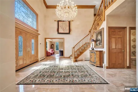 a view of entryway livingroom and hall with wooden floor