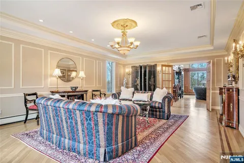a living room with furniture a chandelier and a chandelier