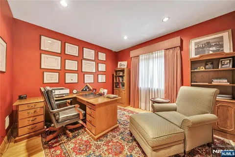 a work room with furniture and large window