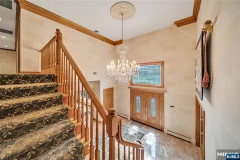 a view of entryway with stairs and chandelier
