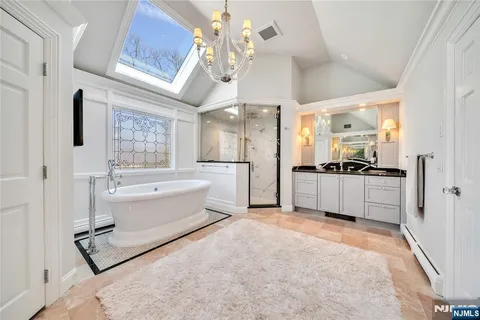 a large white kitchen with a refrigerator a stove a sink and a window