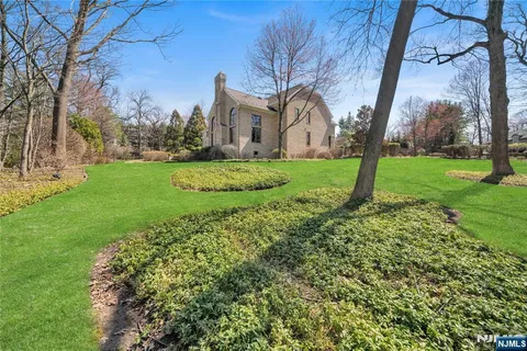a front view of a house with a garden and yard