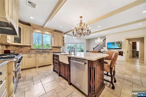 a kitchen with kitchen island granite countertop a sink counter top space appliances and cabinets