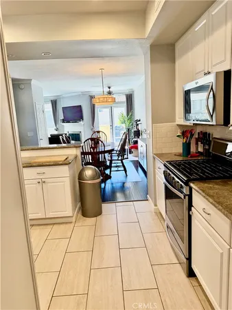 a kitchen with a stove a sink and a microwave