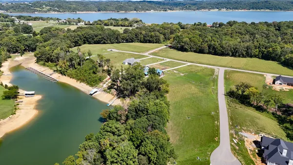 an aerial view of a houses with a lake