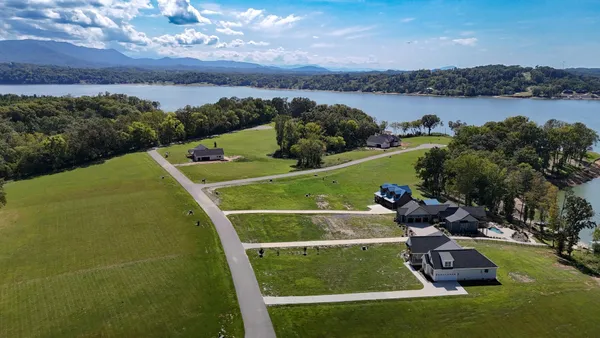 a view of a lake with a yard and mountain view