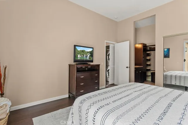 a bedroom with a bed and a tv