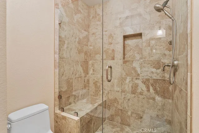 a bathroom with a shower and toilet