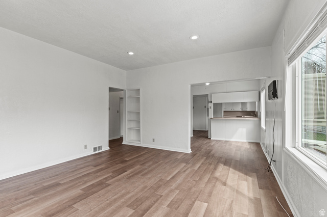 180 South 300 East Logan, UT 84321 - Photo 4 of 35 Unfurnished living room with light vinyl flooring and recessed lighting