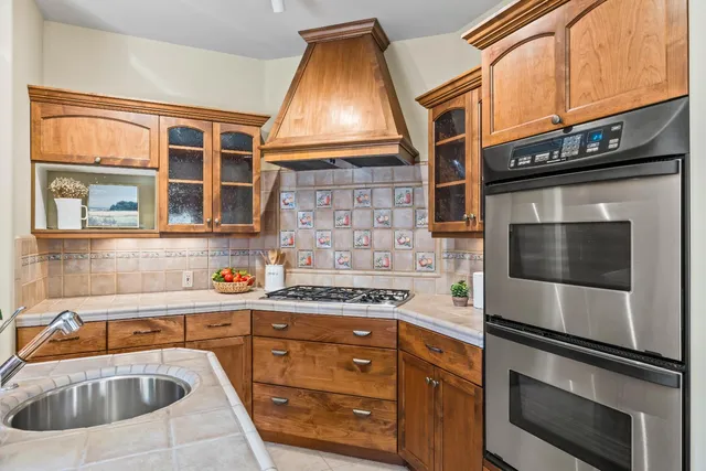 a kitchen with a sink stove and microwave