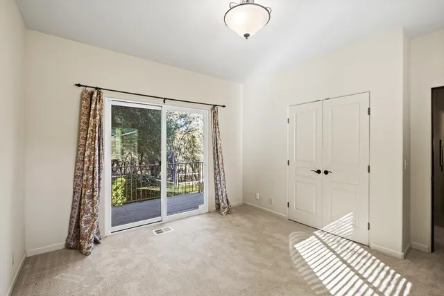 a view of an empty room with glass door
