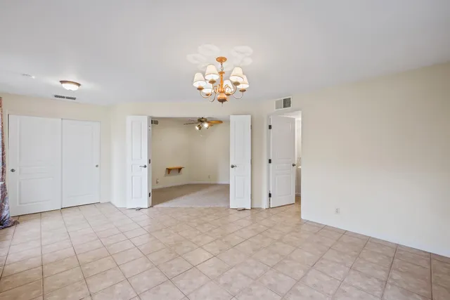 a view of a chandelier fan and entryway