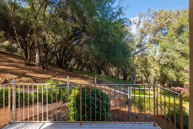 a view of a balcony with floor to ceiling window and wooden fence
