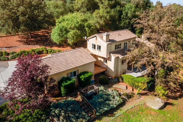 an aerial view of a house with a lake view