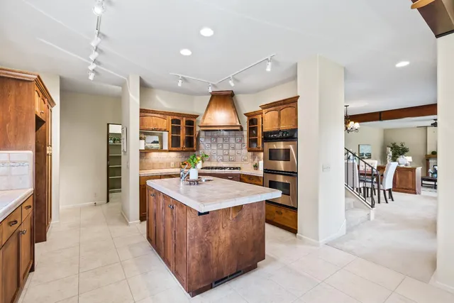 an open kitchen with stainless steel appliances granite countertop a refrigerator and a sink