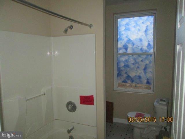 5414 Tramore Road Baltimore, MD 21214 - Photo 19 of 24 a bathroom with a painting on the wall and shower