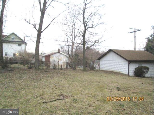 5414 Tramore Road Baltimore, MD 21214 - Photo 23 of 24 a white house that has a tree in front of it