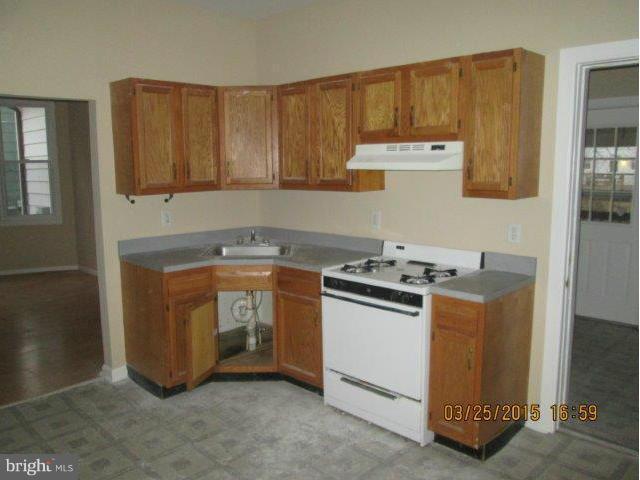 5414 Tramore Road Baltimore, MD 21214 - Photo 10 of 24 a kitchen with a stove and a sink