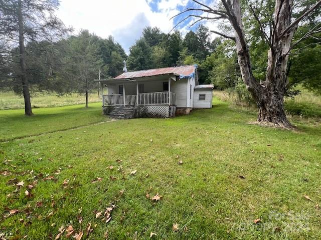 1030 Long Branch Road Green Mountain, NC 28740 - Photo 4 of 16 a view of a house with a backyard