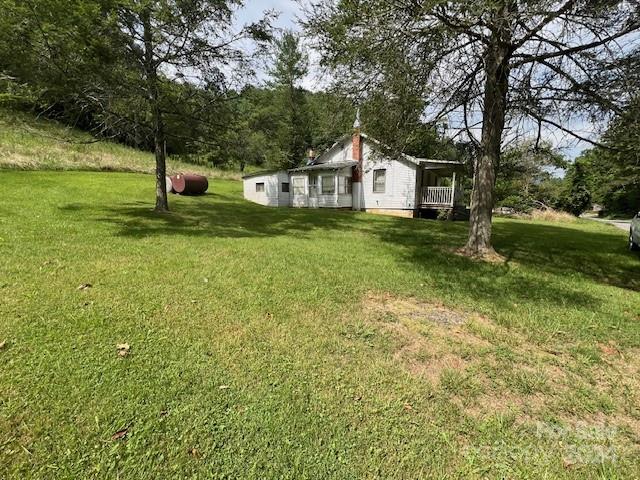 1030 Long Branch Road Green Mountain, NC 28740 - Photo 9 of 16 a front view of a house with garden