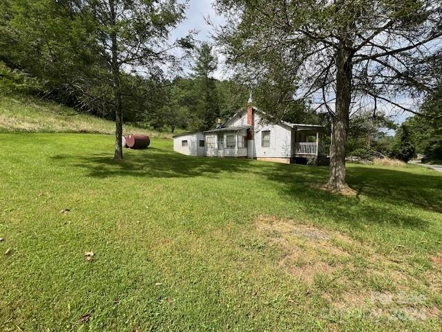 1030 Long Branch Road Green Mountain, NC 28740 - Photo 10 of 16 a view of a house with a yard and sitting area