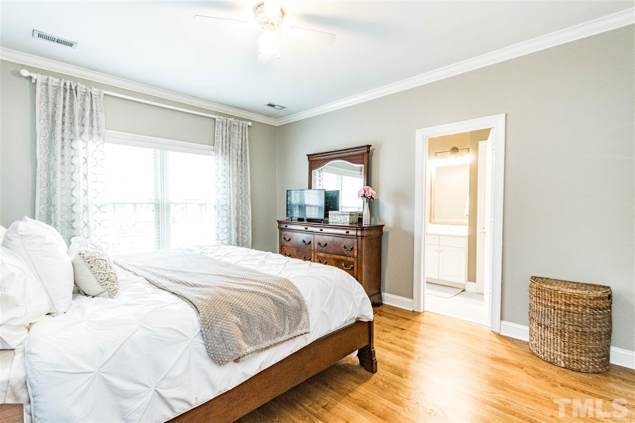 1302 Cameron View Court Raleigh, NC 27607 - Photo 14 of 21 a bedroom with a bed and wooden floor