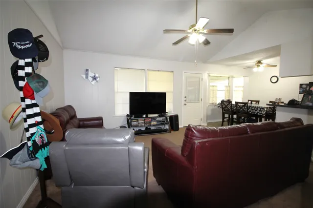 a living room with furniture and a flat screen tv