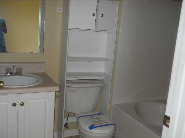 7676 Chablis Circle Navarre, FL 32566 - Photo 9 of 10 a bathroom with a sink toilet and shower