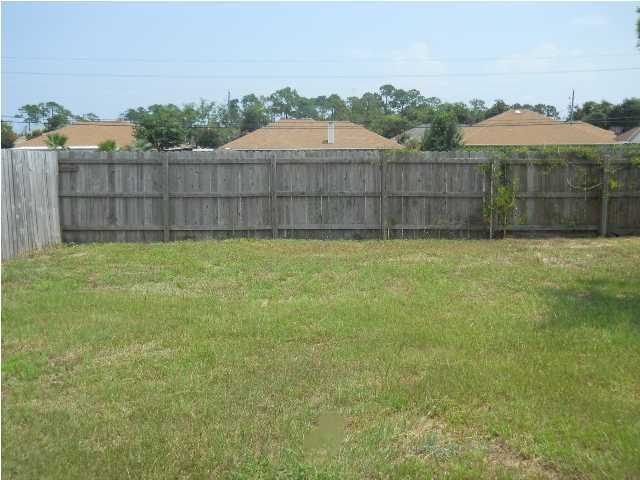 7676 Chablis Circle Navarre, FL 32566 - Photo 10 of 10 a view of a yard with a fence