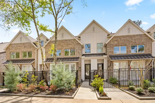 a view of a house with a small yard and wooden floor and fence