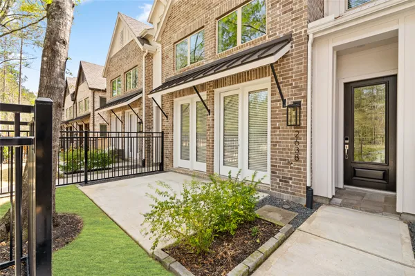 a living room with furniture and a view of kitchen