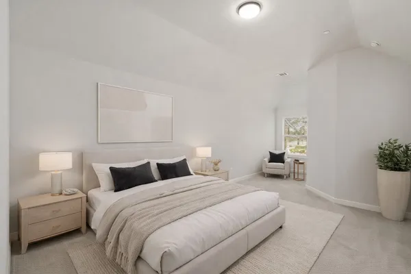 a bedroom with a bed and a lamp