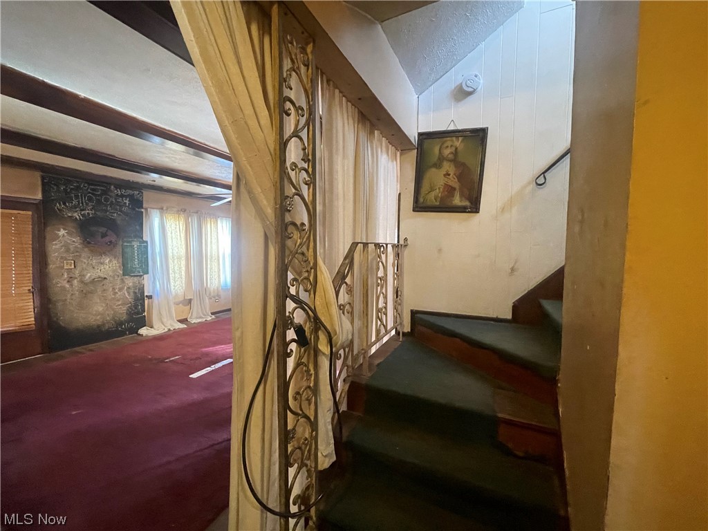 1909 West Schaaf Road Cleveland, OH 44109 - Photo 20 of 48 Stairway with dark colored carpet and beam ceiling
