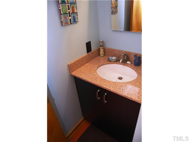 3919 Swarthmore Road Durham, NC 27707 - Photo 16 of 24 Guest bathroom features tiled bath/shower, solid surface vanity and "green" flooring. Bathroom