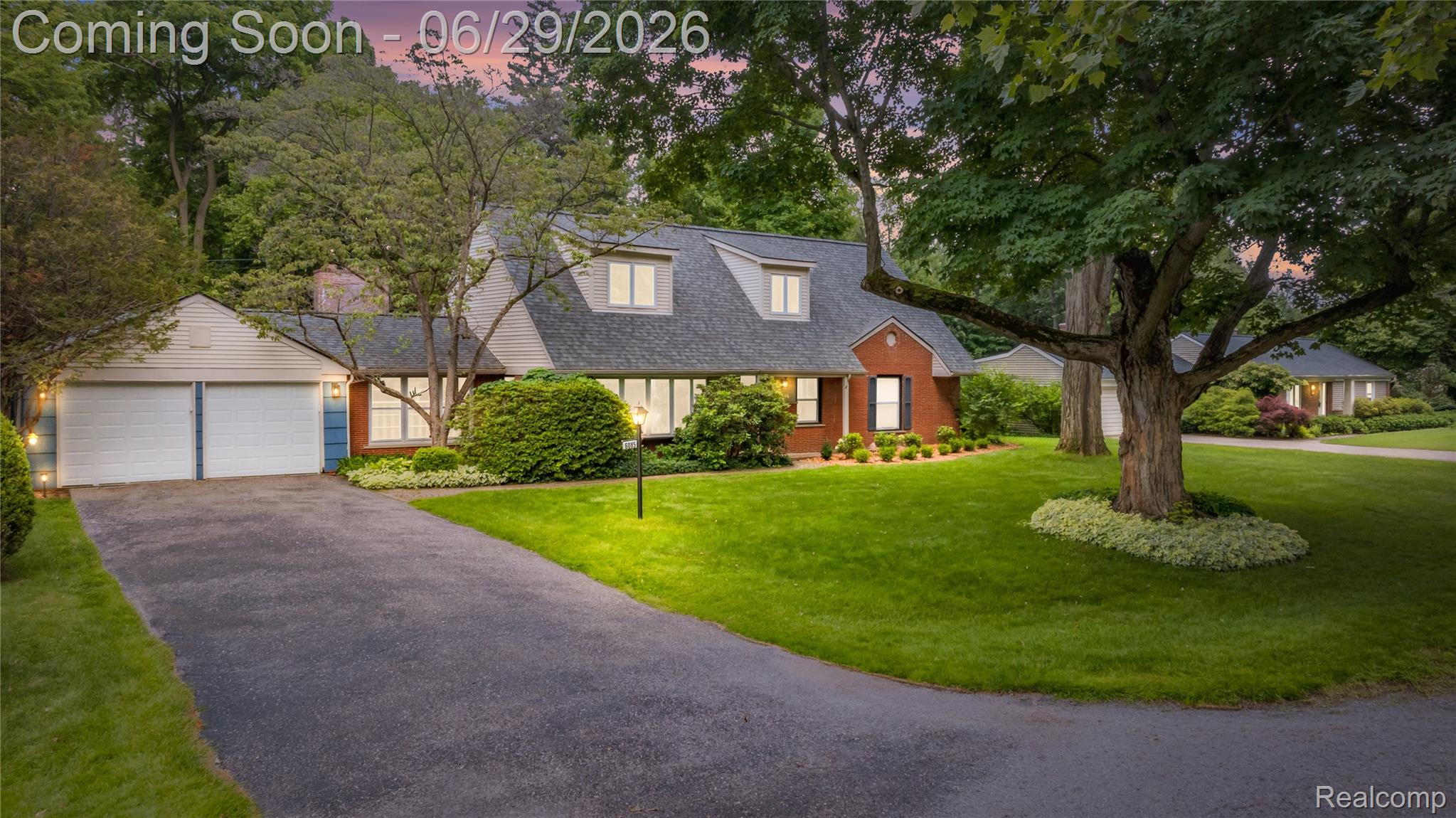 6085 Worlington Road Bloomfield Hills, MI 48301 - Photo 1 of 75 Brick and siding exterior featuring a two-car garage, dormer windows, and a paved driveway
