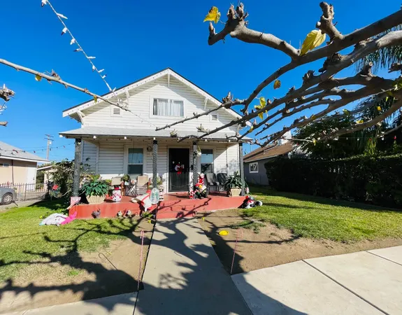 a front view of a house with yard and outdoor seating