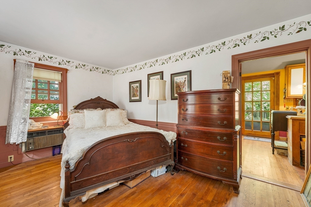 8 Ferry Road Salisbury, MA 01952 - Photo 18 of 42 a bedroom with a bed and wooden floor