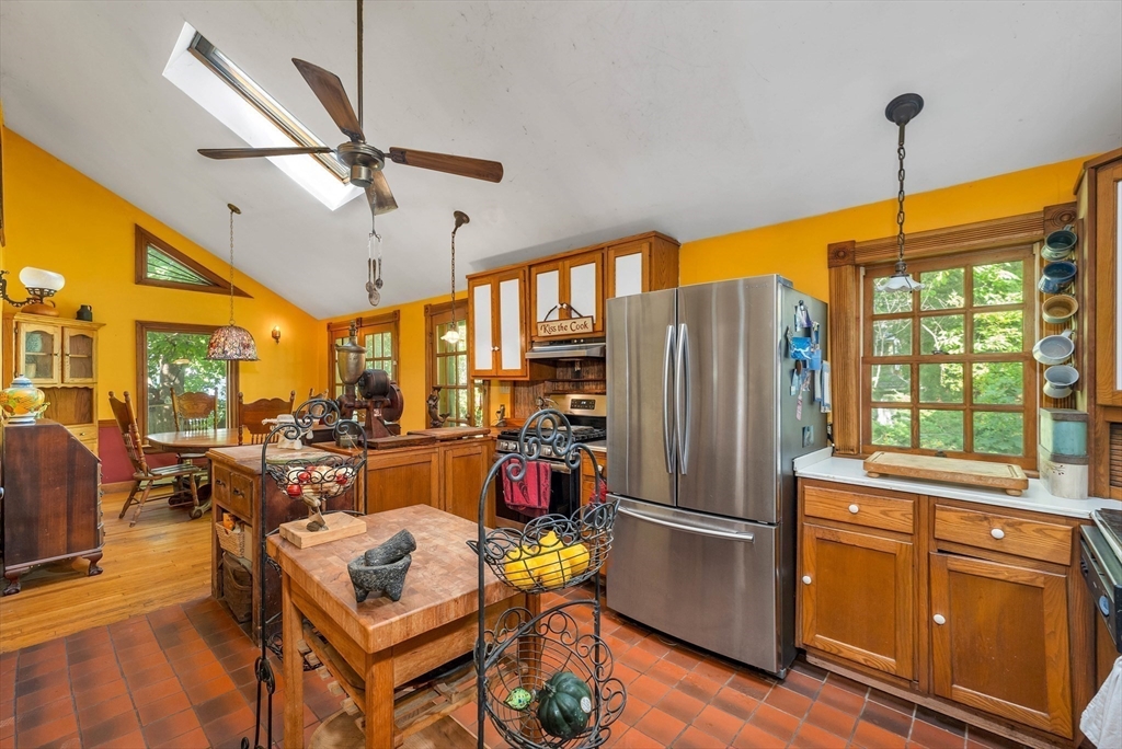 8 Ferry Road Salisbury, MA 01952 - Photo 3 of 42 a kitchen with stainless steel appliances granite countertop a refrigerator oven stove dining table and chairs with wooden floor