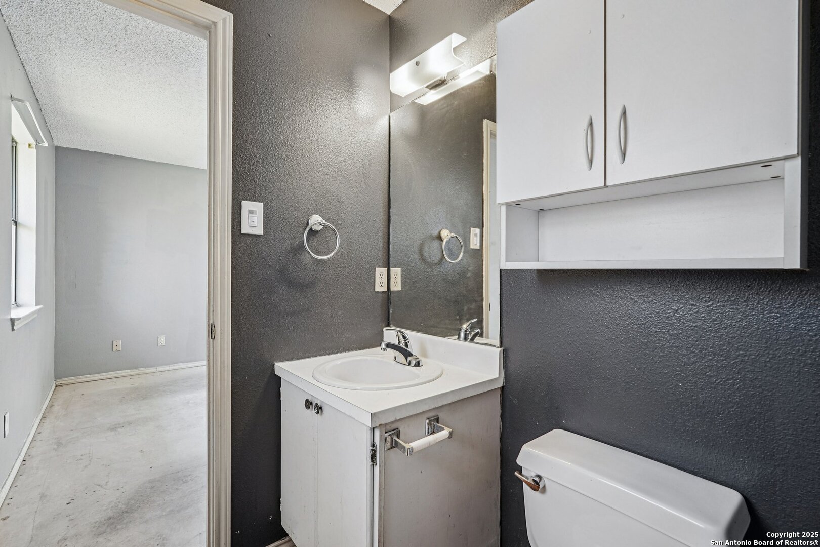 1601 Newton Street Kerrville, TX 78028 - Photo 13 of 23 a bathroom with a sink a toilet and mirror