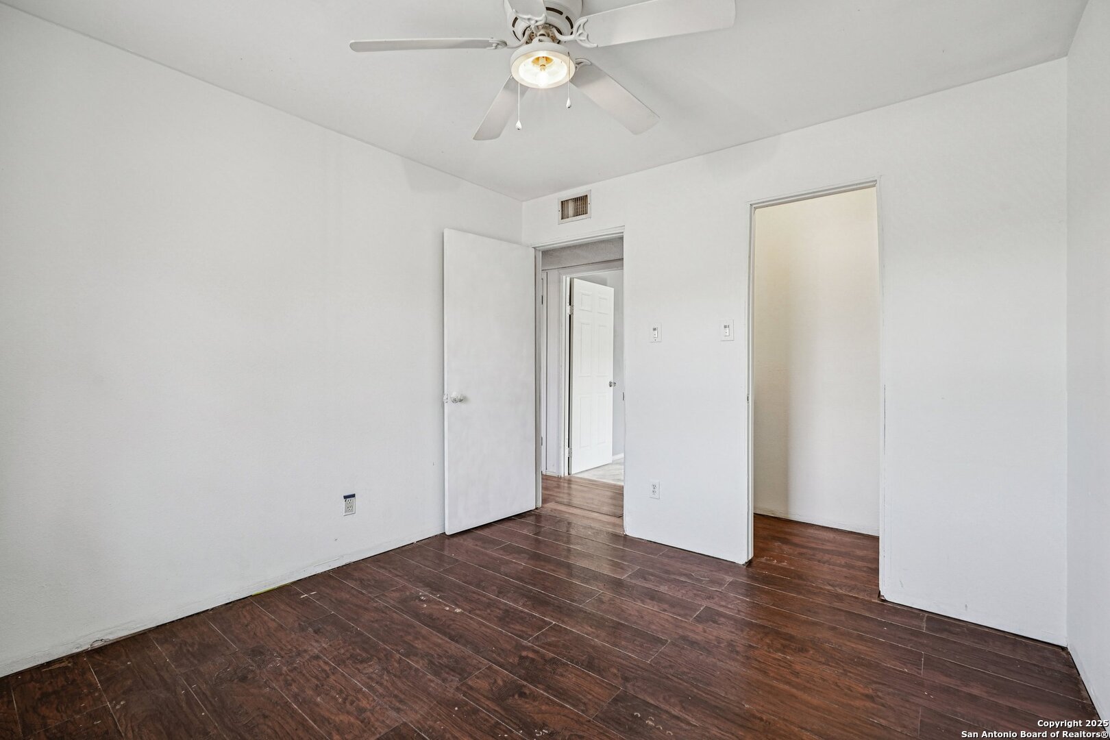1601 Newton Street Kerrville, TX 78028 - Photo 20 of 23 an empty room with wooden floor and ceiling fan
